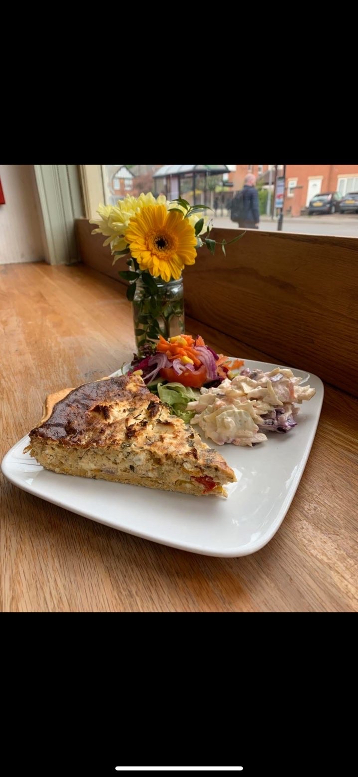 Homemade quiche served with fresh salad and slaw